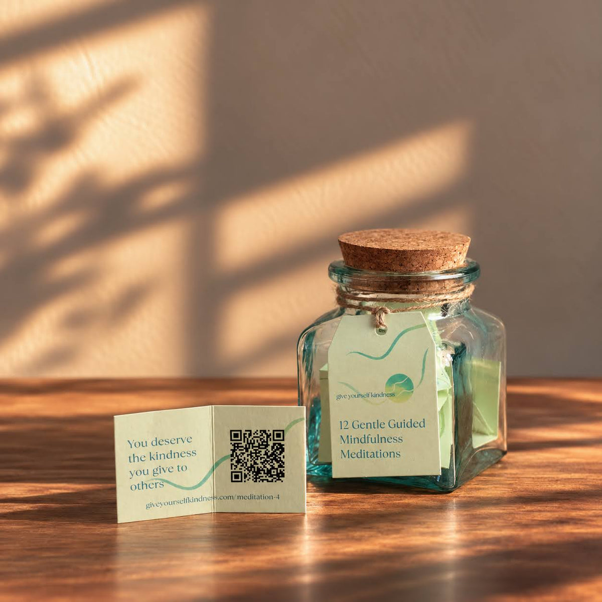 Meditation card with a QR code to play the guided meditation, beside the Meditation Jar in warm sunlight