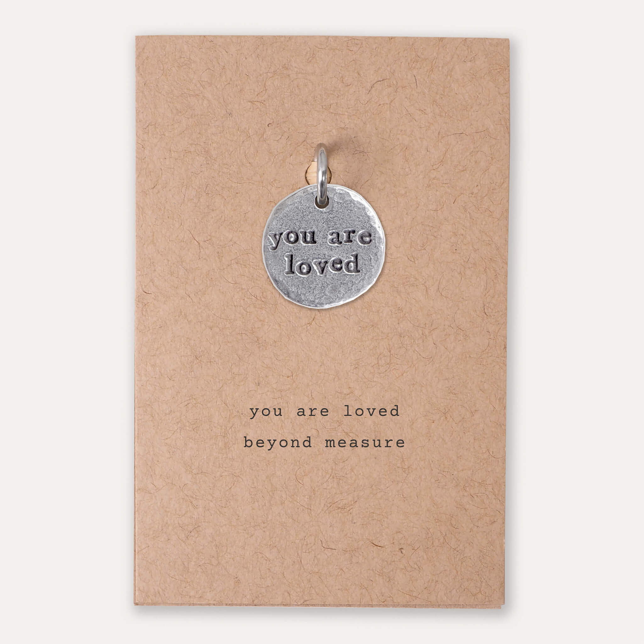 you are loved charm on card with writing you are loved beyond measure