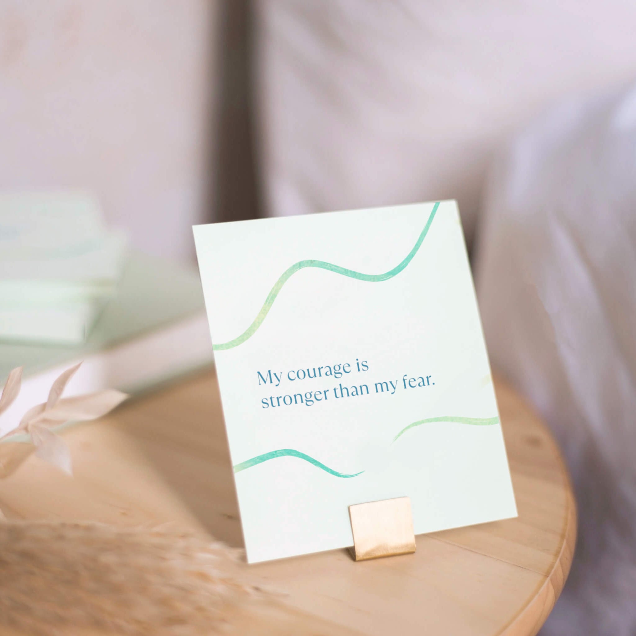 affirmation card on stand on bedside table