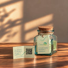 Meditation card with a QR code to play the guided meditation, beside the Meditation Jar in warm sunlight