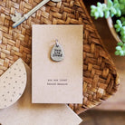 you are loved charm on card that says 'you are loved beyond measure'